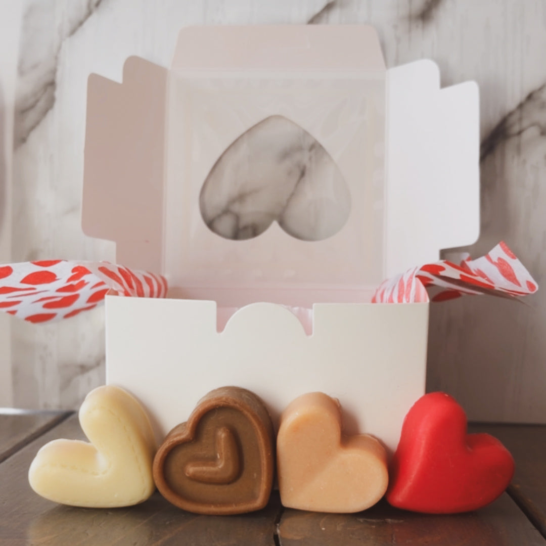 Heart-shaped soaps in a decorative box with a marble design.