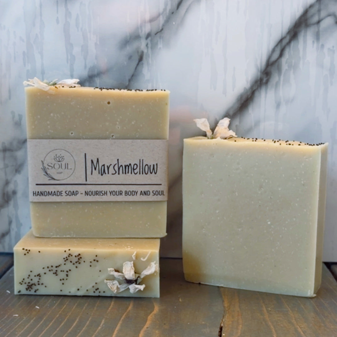 Three handmade soap bars named Marshmellow with a visible label on a marble surface
